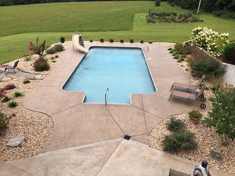 Blue vinyl liner pool with steps and handrail