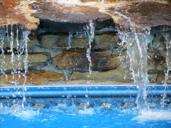 water fall with rock feature in pool
